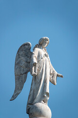 Obraz premium Statue of an Angel at the top of tower.