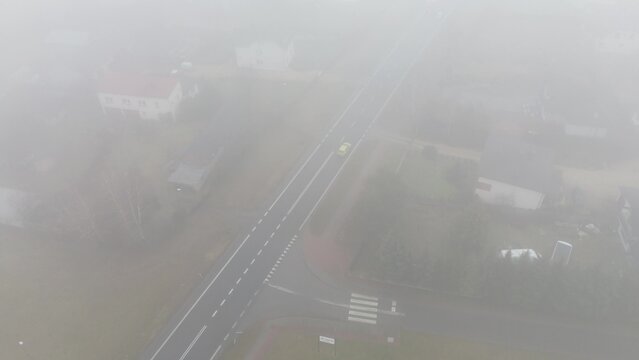 Foggy morning commute through suburban neighbourhood