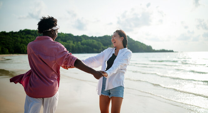 Stylish young multiethnic people in trendy summer outfits enjoying a sunny day at a beach resort
