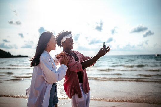Pure happiness. A young diverse, multiethnic couple enjoys every moment of their tropical getaway