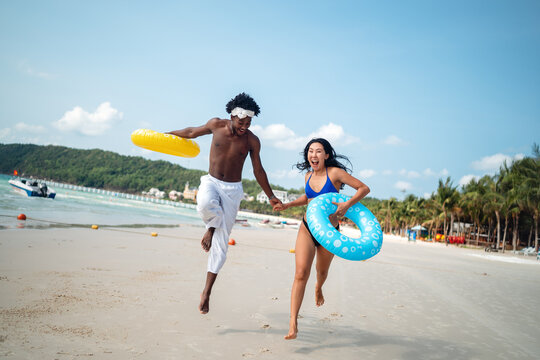Pure happiness. A young diverse, multiethnic couple enjoys every moment of their tropical getaway