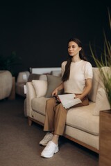 Obraz premium Woman choosing upholstery fabric samples in furniture store