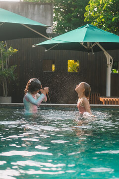 Child in swimming pool, happy summer lifestyle with water play, sunshine, relaxation and bright family vacation energy in a clean outdoor setting, soft natural light, realistic detail, clean