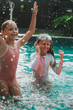 Child in swimming pool, happy summer lifestyle with water play, sunshine, relaxation and bright family vacation energy in a clean outdoor setting, soft natural light, realistic detail, clean