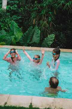 Child in swimming pool, happy summer lifestyle with water play, sunshine, relaxation and bright family vacation energy in a clean outdoor setting, soft natural light, realistic detail, clean