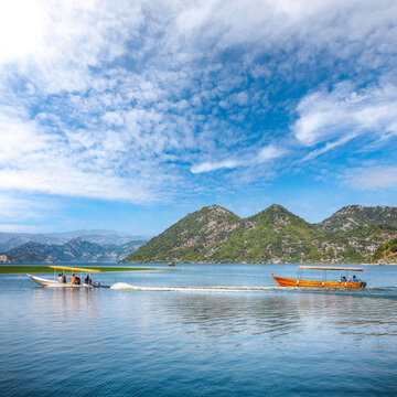 Amazing view of Skadar lake surrounded by green mountain peaks on a sunny day.