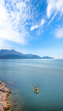 Amazing view of Skadar lake surrounded by green mountain peaks on a sunny day.