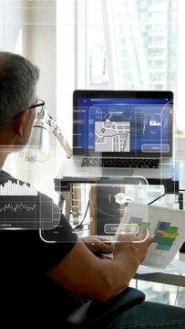Vertical video: Man tapping plans and laptop design, summoning AR UI maps CONFIRM confirming order