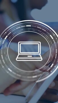 Vertical video: Teen student tapping tablet activating rotating ringed HUD laptop icon for tech use