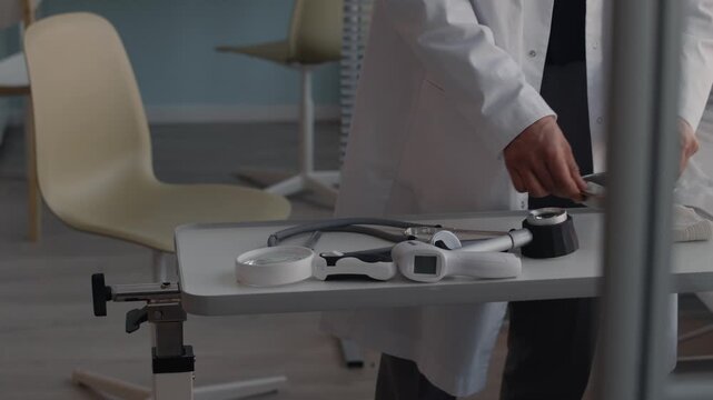 A scientist works in a clean pharmaceutical laboratory using a microscope and advanced medical technology equipment for healthcare production inside an industrial clinic room
