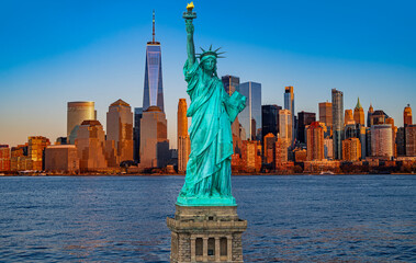 Naklejka premium NYC panoramic cityscape and Statue of Liberty. Manhattan towers and Statue of Liberty. Evening with the Statue of Liberty. Symbol of Freedom in USA. New York City panorama with Liberty Statue.
