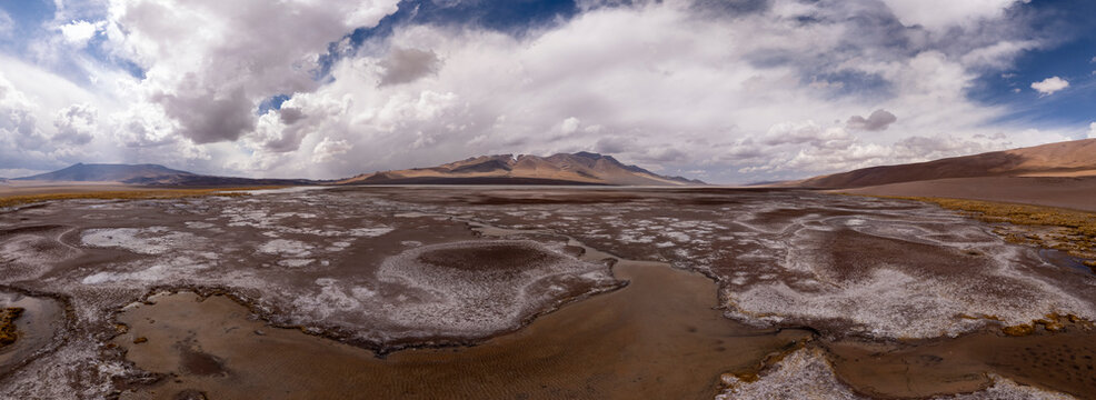 Expansive desert salt flat under a dramatic sky