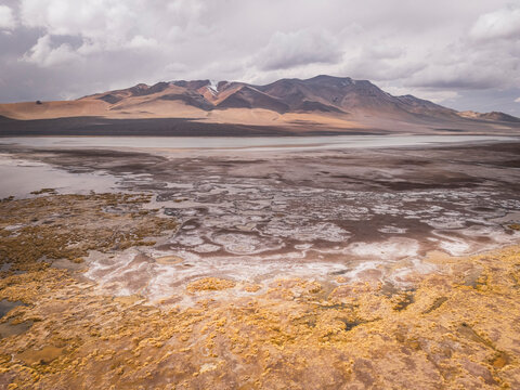 Expansive view of a high altitude salt flat and mountains