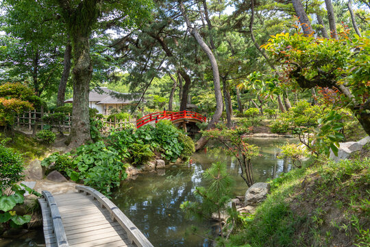 Wooden and red bridges in Shukkei-en Garden, Hiroshima, Japan