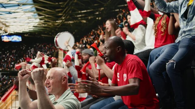 Passionate soccer fans erupting in celebration after winner goal during the final whistle of intense football match with crowd energy and team spirit.