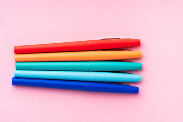 Fototapeta premium coloured rainbow pens on a pink background