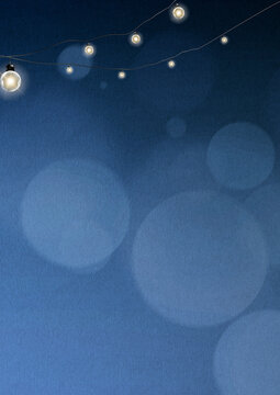 Blue bokeh background with glowing string lights and soft festive atmosphere