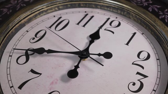 A close-up time lapse of an antique style wall clock face with the hands spinning rapidly, representing the fast passage of time.