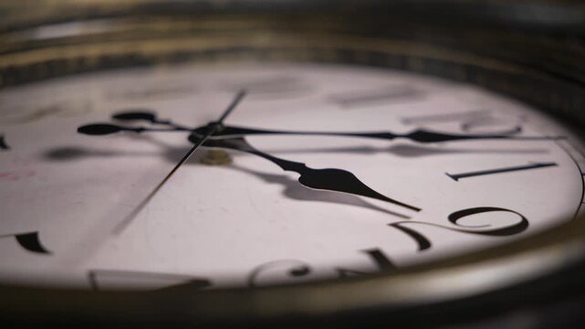 Timelapse macro static shot of an antique clock face. Watch hands spin rapidly across roman numerals illustrating the fast passage of time.