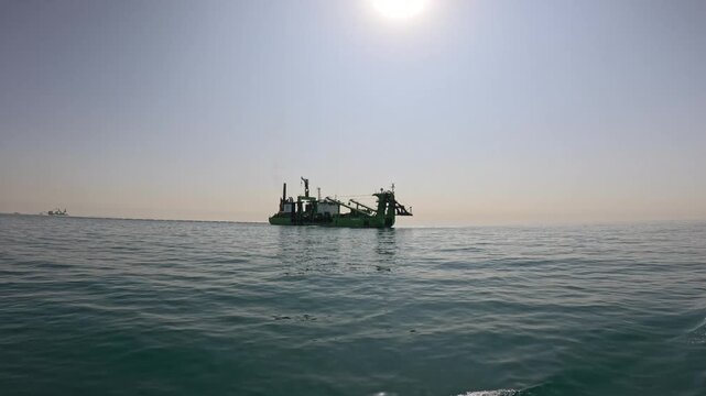 Cutter suction dredger working on a access channel. Footage in slowmotion.