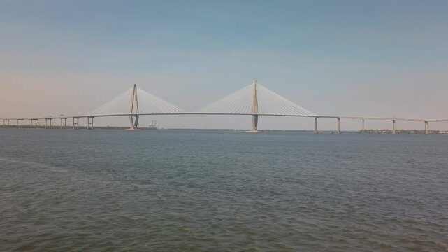 Gimbal wide shot from a moving ferry boat passing by Ravenel Bridge in Charleston, South Carolina. 4K at 60 FPS Slow Motion