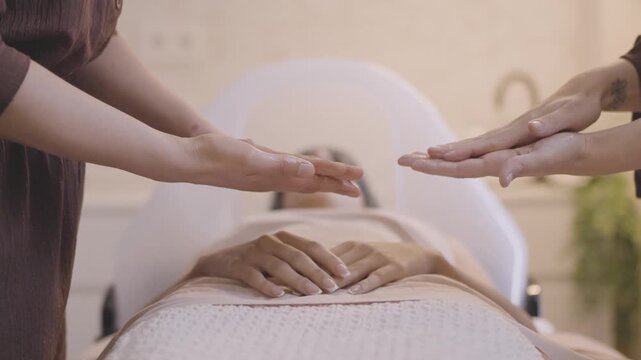 Masseuses performing a four hands belly massage at a wellness spa