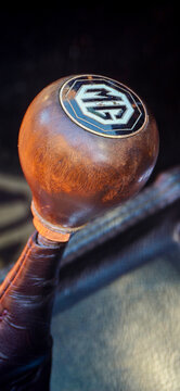 Saint Petersburg, Russia - May 23, 2026: Close-up of vintage MG car gear shift knob with wooden finish and logo, showcasing classic automotive design elements