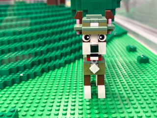 Obraz premium Lego dog made from bricks on green baseplate