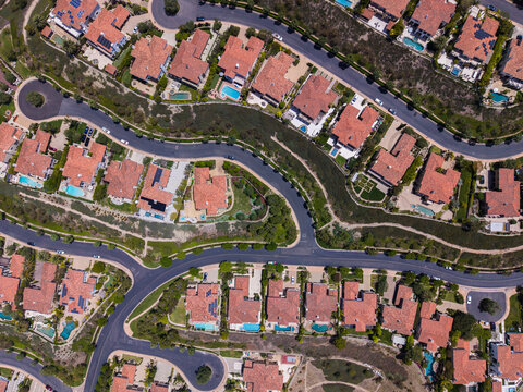 Overhead drone shot of symmetrical luxury houses and winding streets in Newport