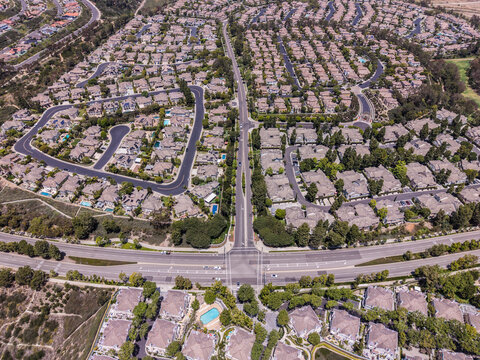 Wide aerial perspective of vast residential community and intersection in Newport