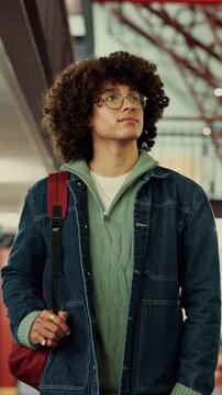 Man, student and walk with backpack on campus for education, study material and lesson change. Thinking, male person or morning journey to attend class, university navigation and learning scholarship