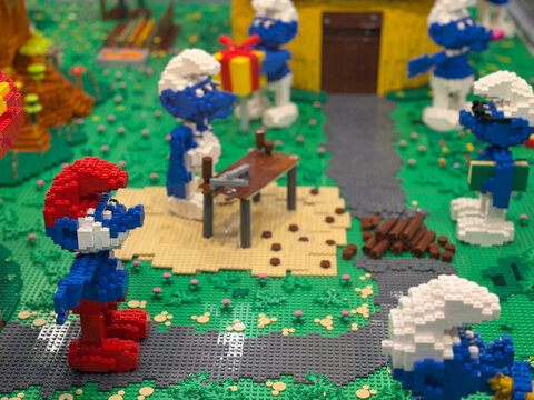 Lego smurfs in park with gift and picnic table