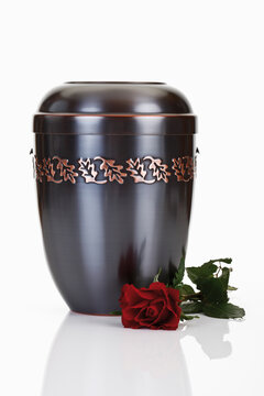 Cremation urn and red rose