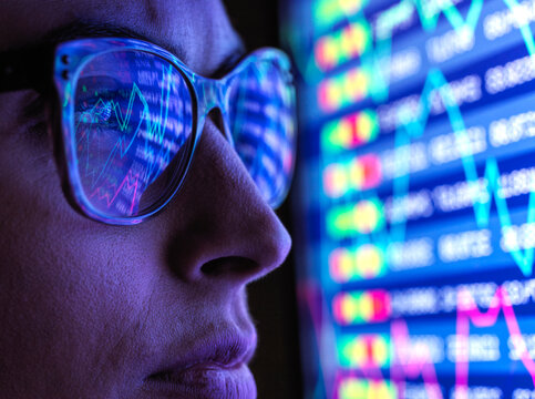 Female analyst viewing financial market data on a screen