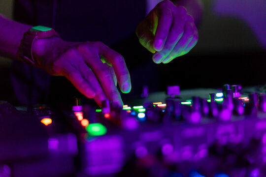 DJ working on mixing board