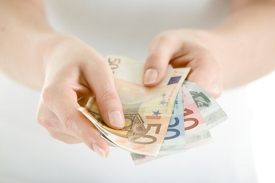 Hand Holding Euro Notes, close-up
