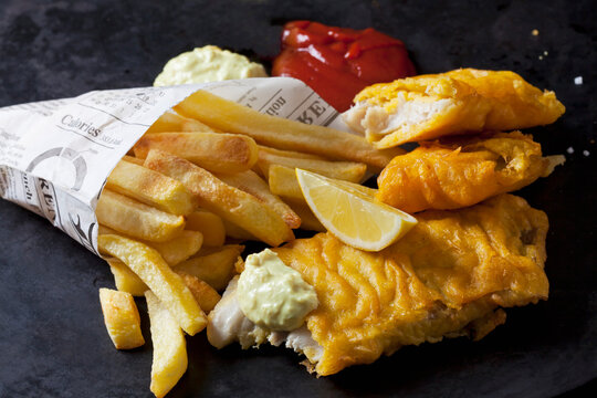 Fish and chips with remoulade, ketchup and lemon slice