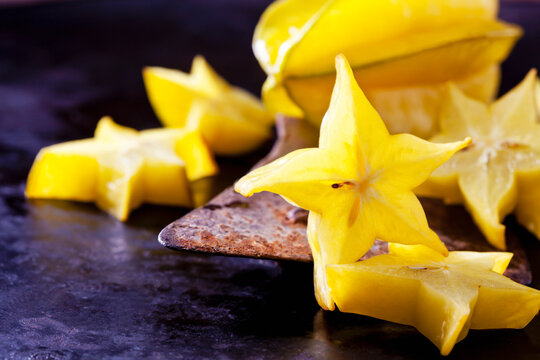 Sliced starfruit on an old cleaver