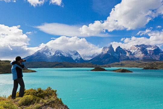 South America, Chile, Patagonia, Female photographer capturing an image ot torres del paine mountains