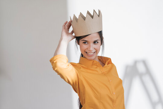 Happy young woman with crown on her head