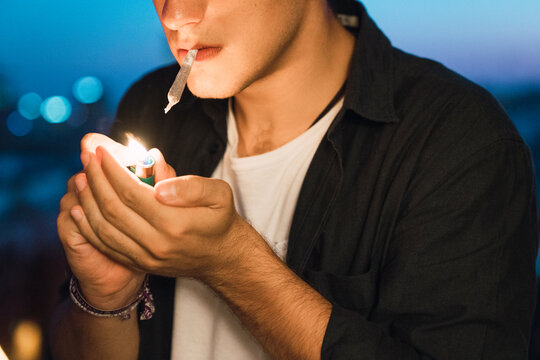 Young man smoking a joint