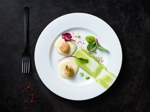 Scallops on nut butter with pea and mint puree