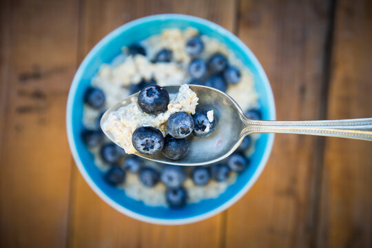 Spoon of overnight oats with blueberries, close-up