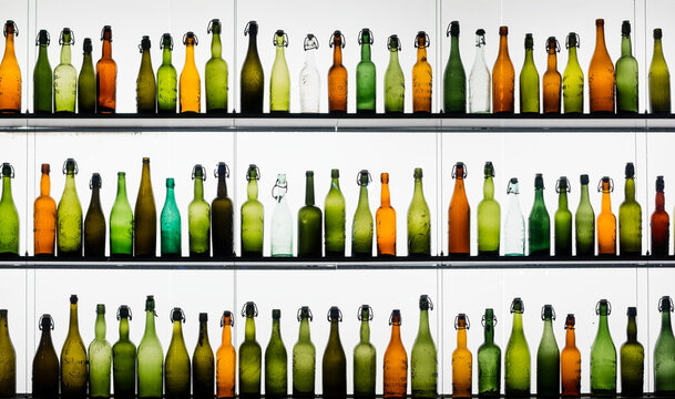 Three rows of different beer bottles