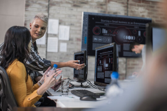 Adult Education, instructor talking to student at computer training centre