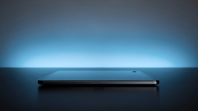 Modern smartphone lying flat on a dark surface with a glowing blue background, studio lighting