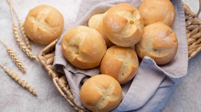 Freshly baked kaiser rolls in wicker basket