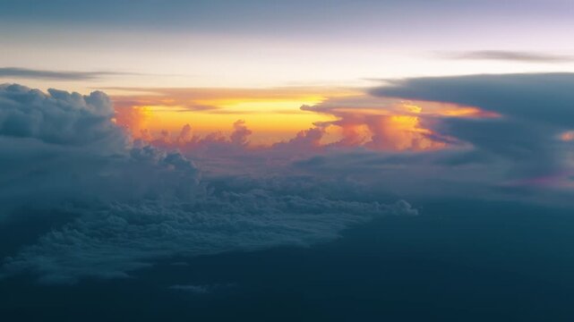 Breathtaking aerial view above thick cloud layers at sunset with golden and orange light illuminating dramatic cumulus formations. Ethereal atmosphere with warm tones fading into cool blue hues.
