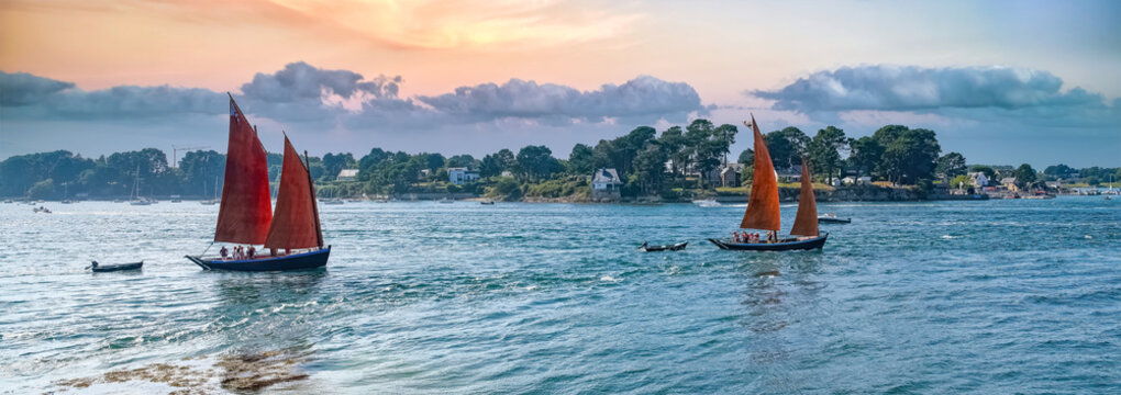 Old boat at the Ile-aux-Moines island, with red sails, traditional boat in the Morbihan gulf, Brittany