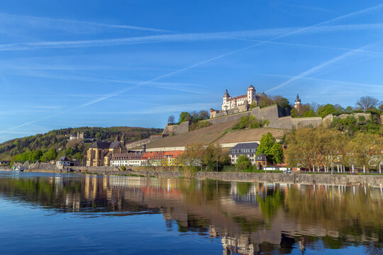 Marienberg Fortress and Kappele Pilgrimage Church view from Main river in Wurzburg, Germany. Hillside perspective under a blue sky